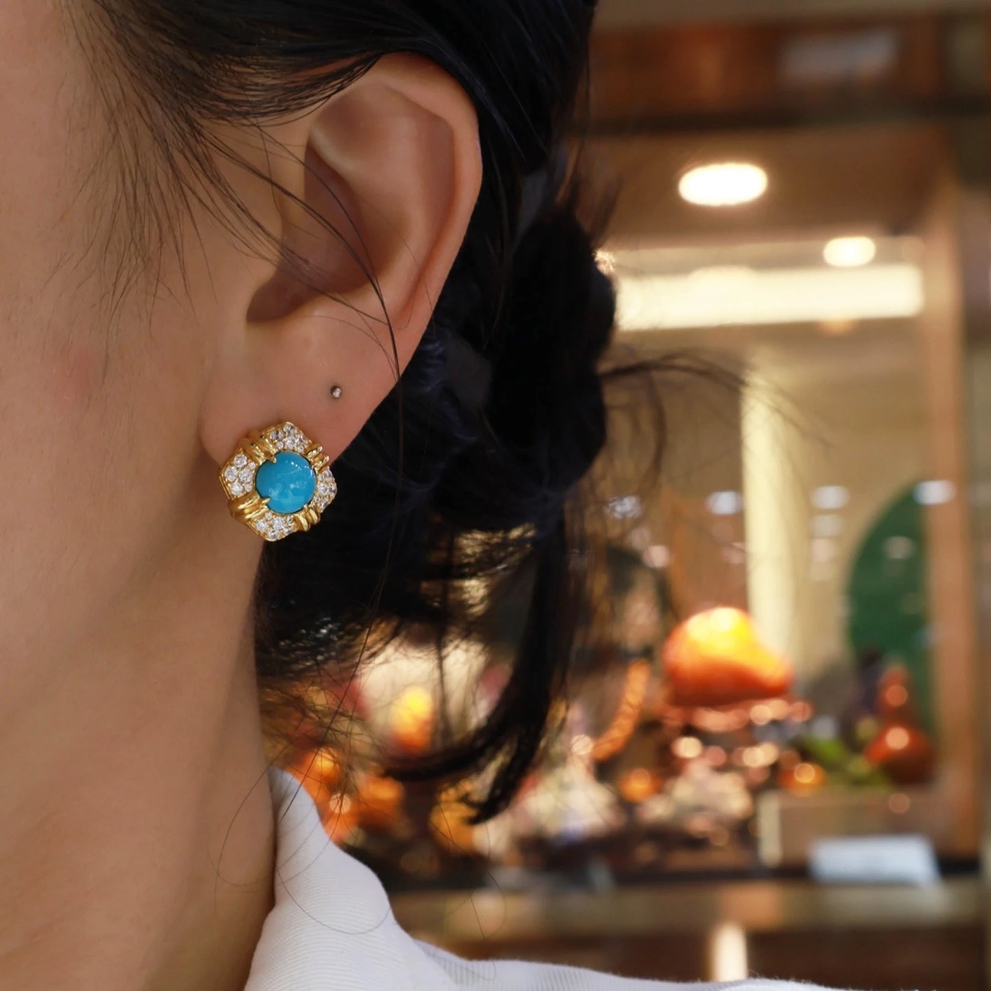 woman wearing elegant blue turquoise gold stud earrings vintage style