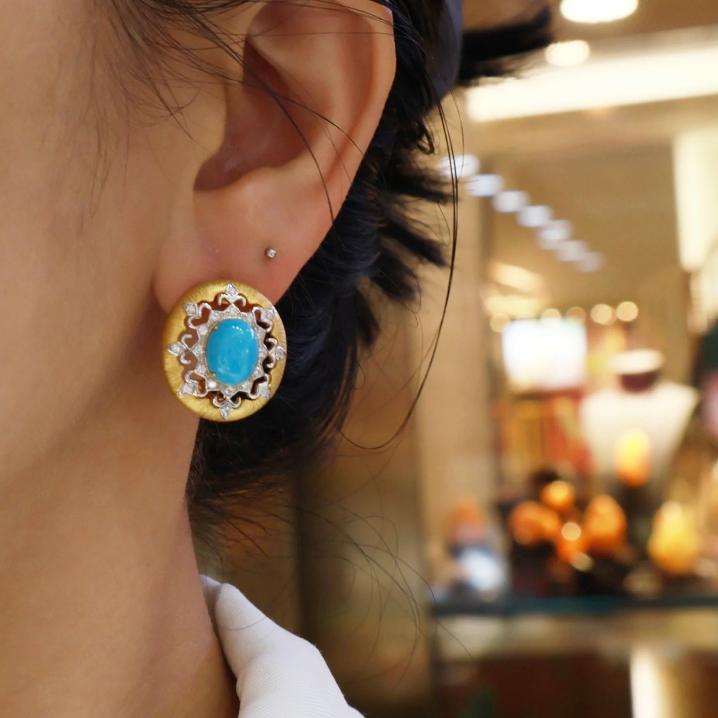 woman wearing vintage turquoise halo stud earrings with gold finish