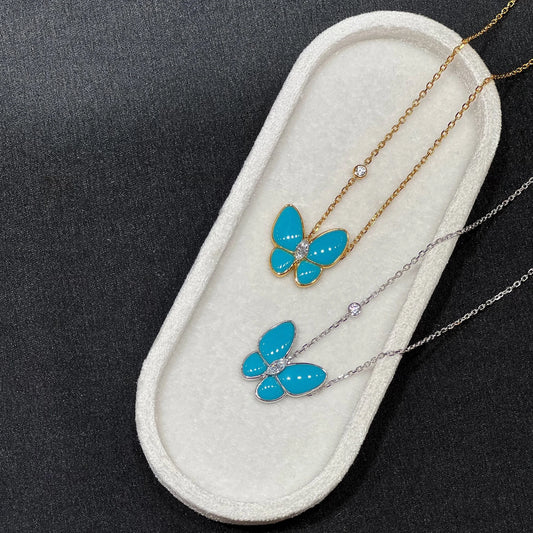 Blue and silver created turquoise butterfly necklaces on a white background
