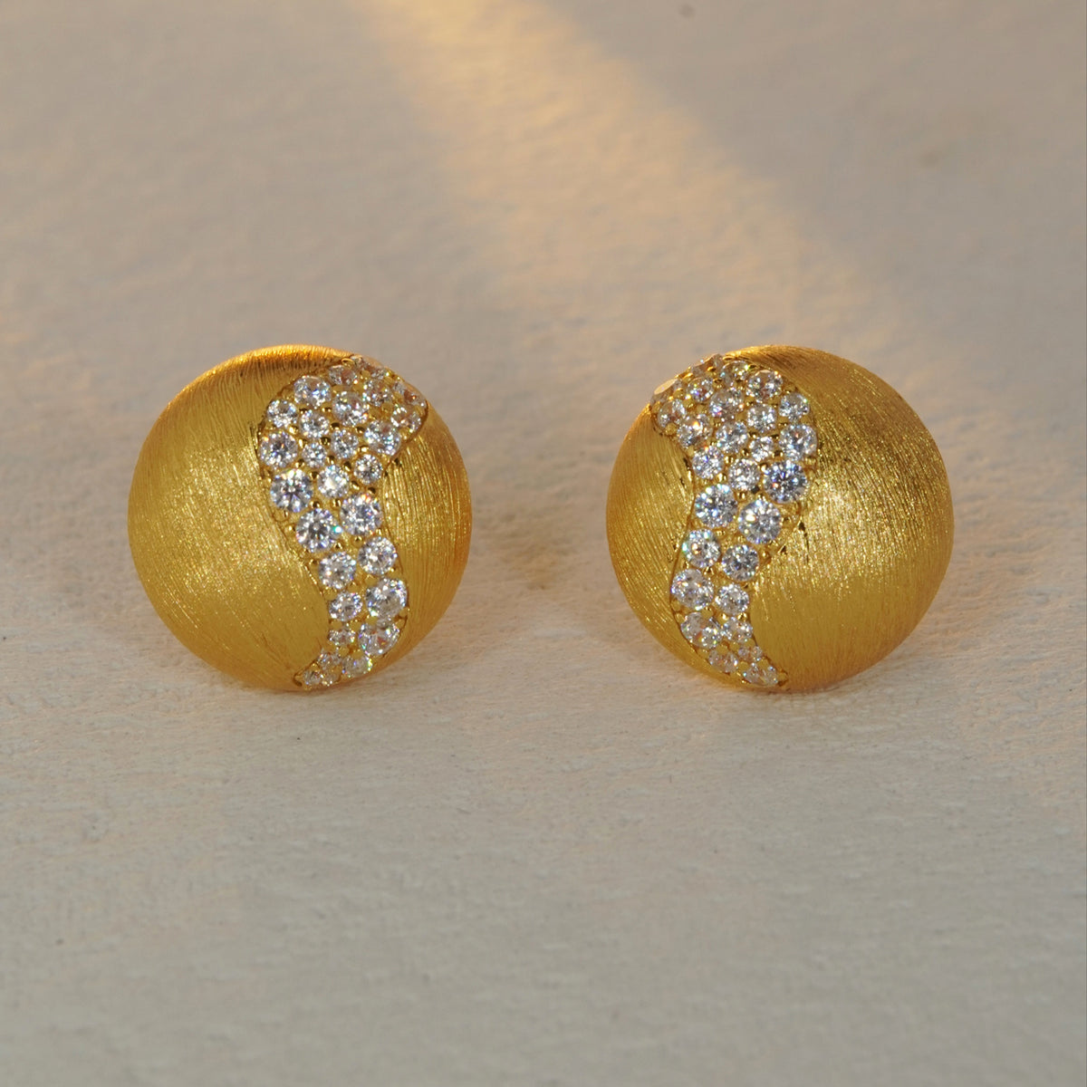 brushed gold CZ accent stud earrings with minimalist round design
