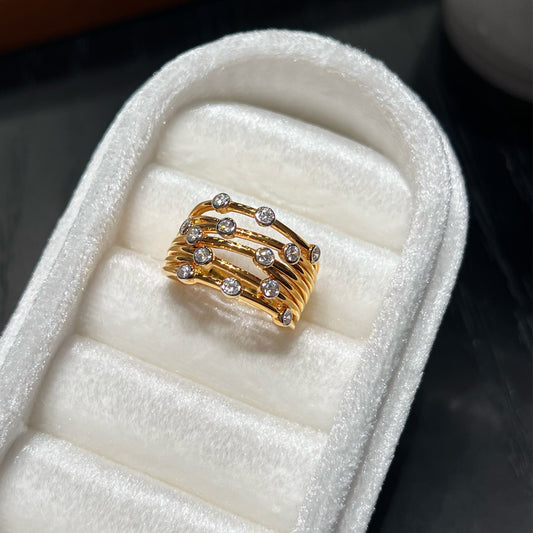 Scattered CZ multi-band gold-plated ring on a jewelry tray - main view