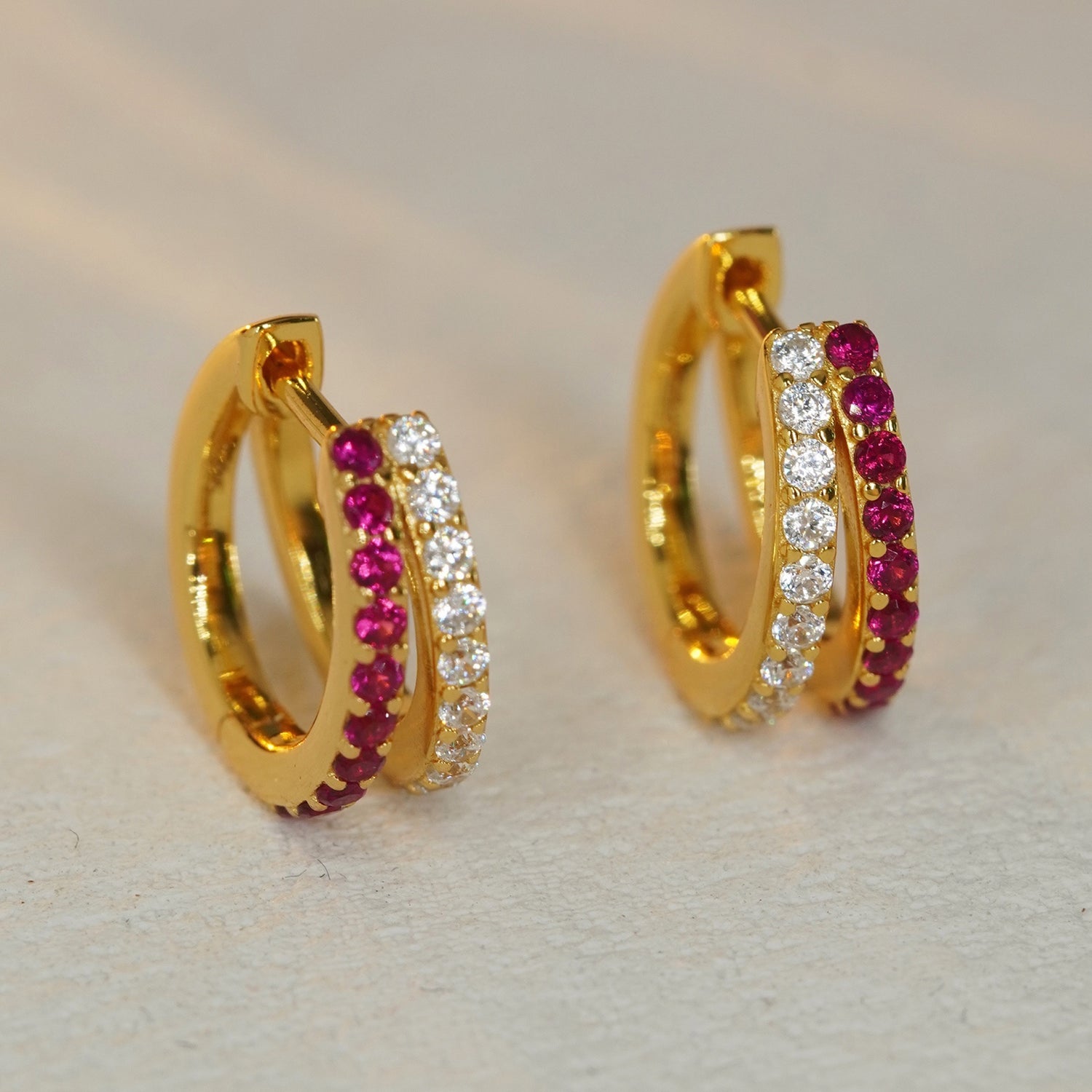 ruby and CZ gold huggie hoop earrings with sparkling gemstone details