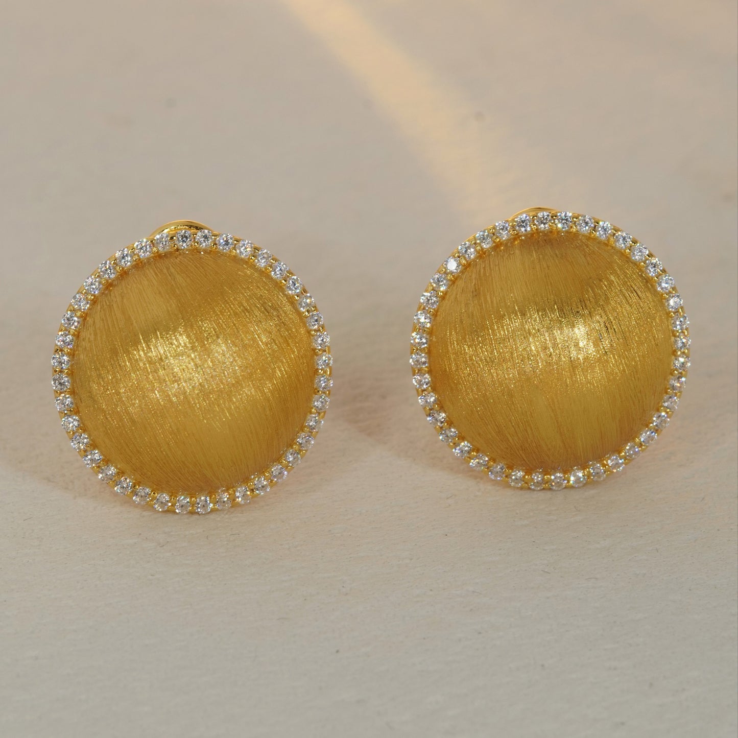 brushed gold round CZ halo stud earrings with sparkling gemstone border