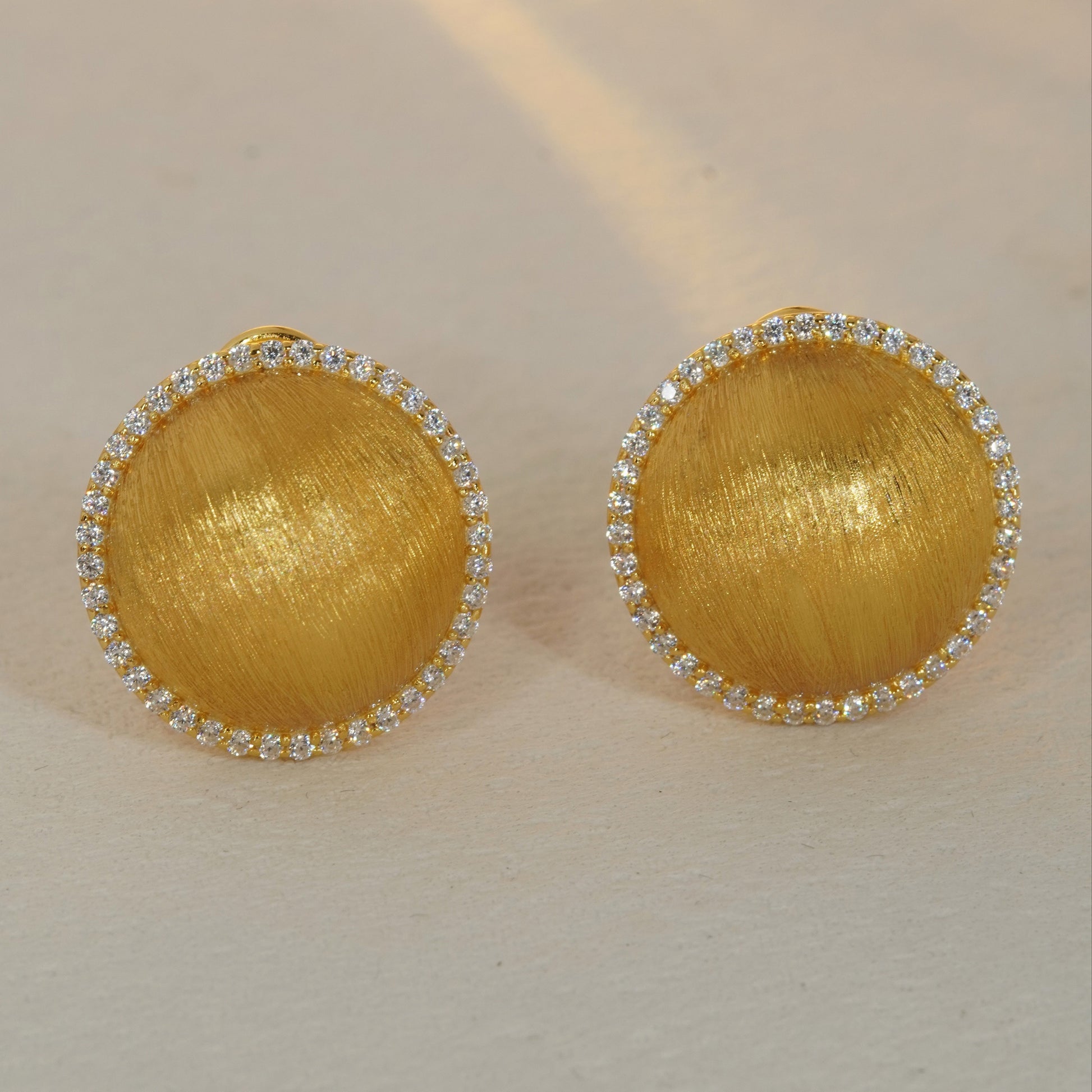 brushed gold round CZ halo stud earrings with sparkling gemstone border