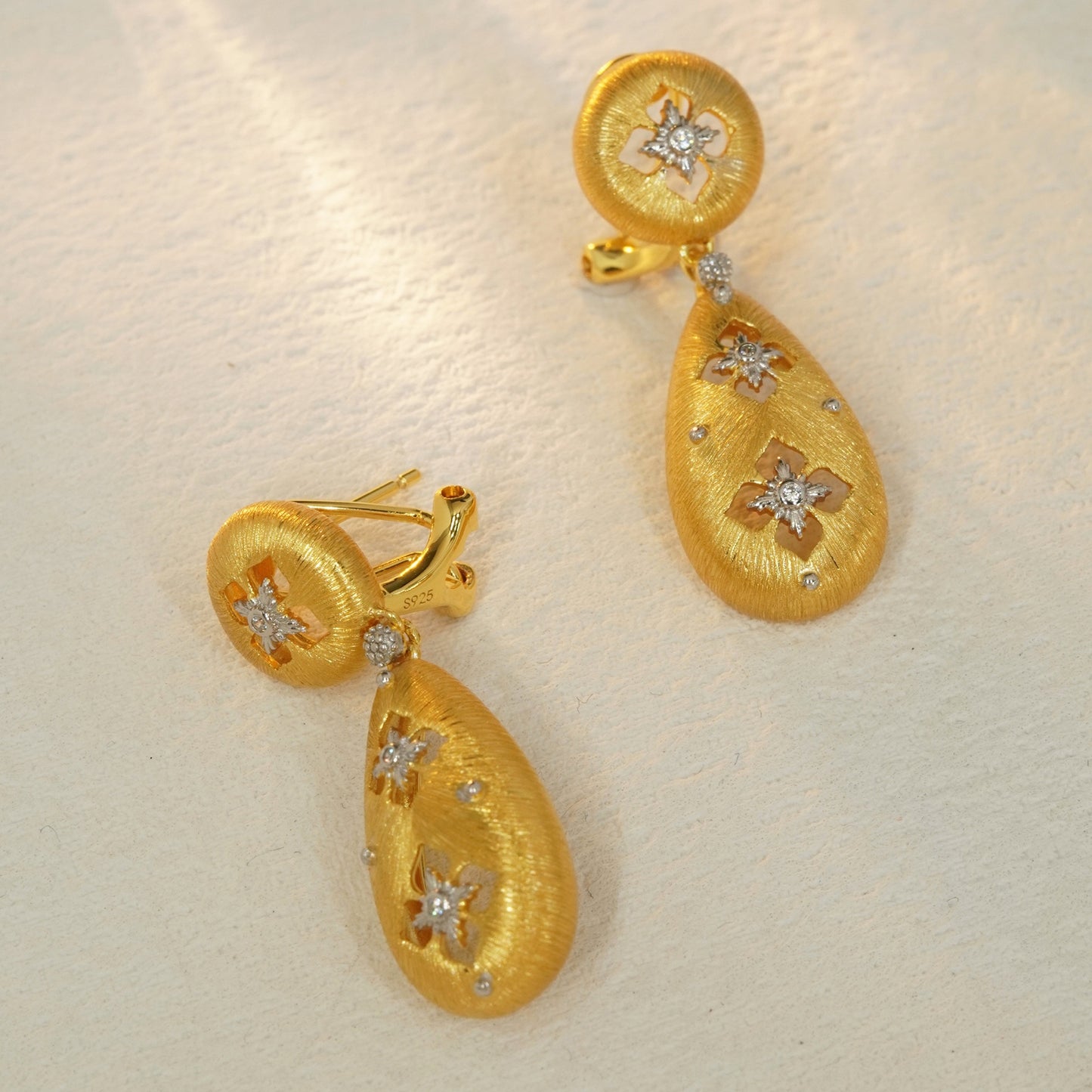 Brushed gold floral drop earrings with sterling silver base and hinged closure