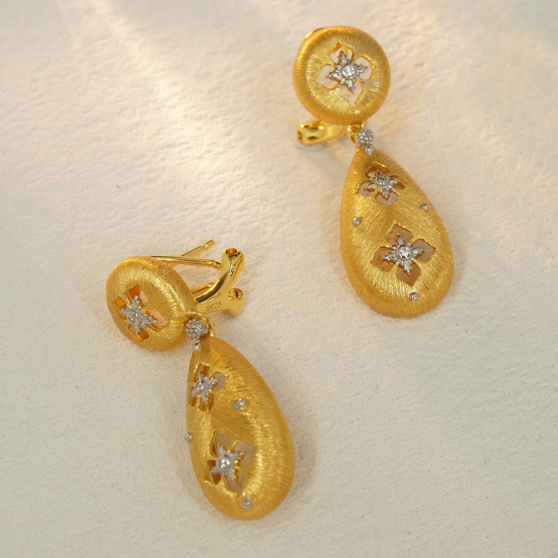 Brushed gold floral drop earrings with sterling silver base and hinged closure