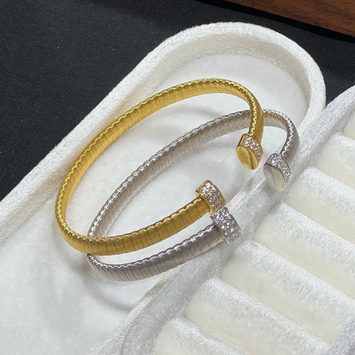 Brushed gold and silver cuff bracelets with pavé cubic zirconia ends