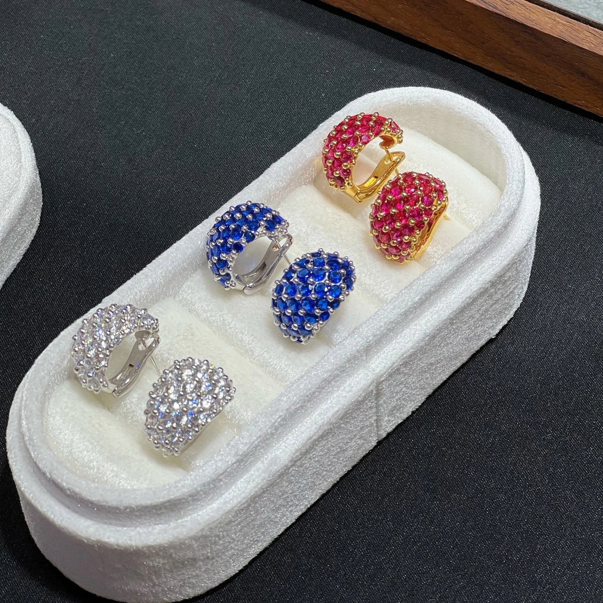Hinged backs of red blue and clear wide clip-on earrings