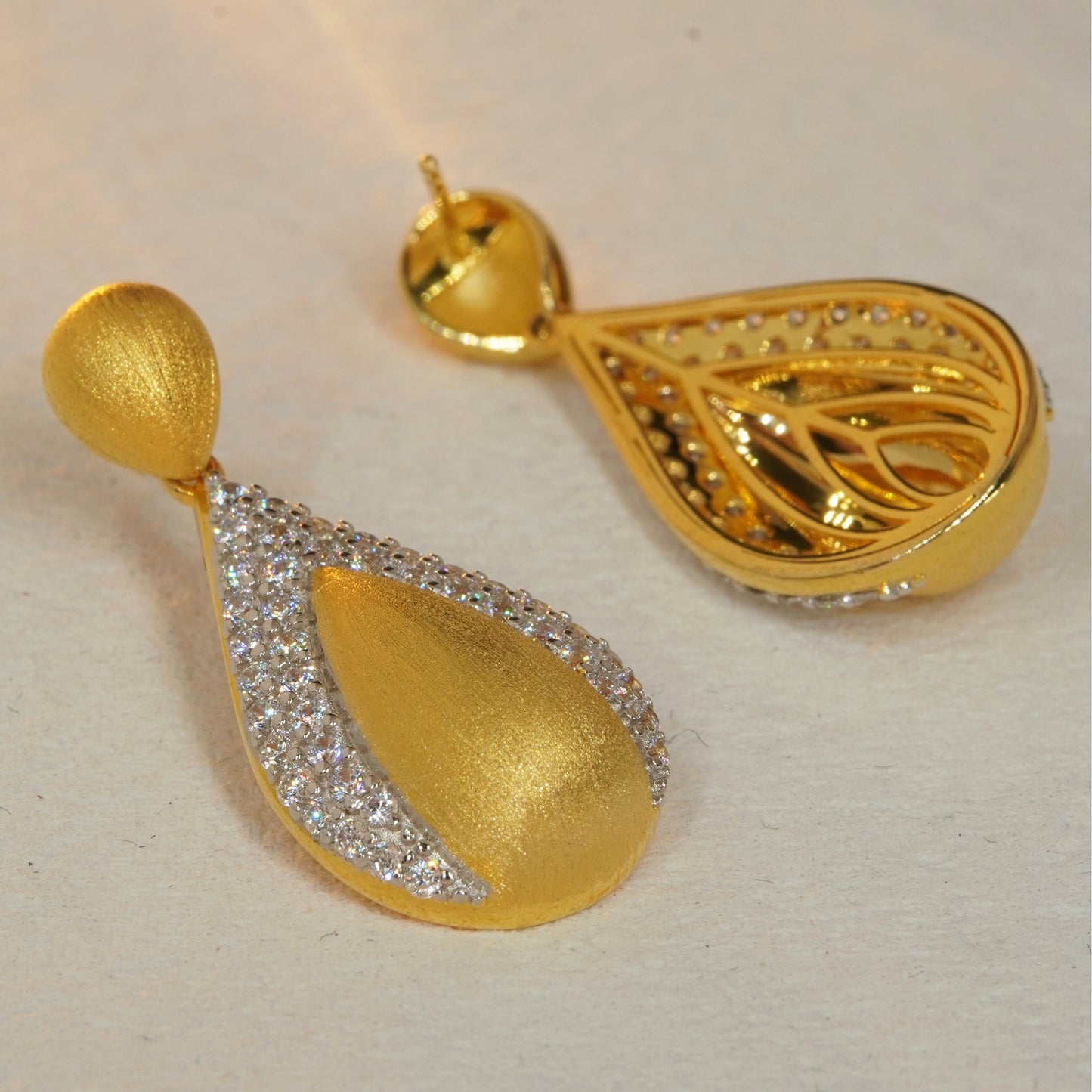 back view of brushed gold teardrop earrings showing sterling silver craftsmanship
