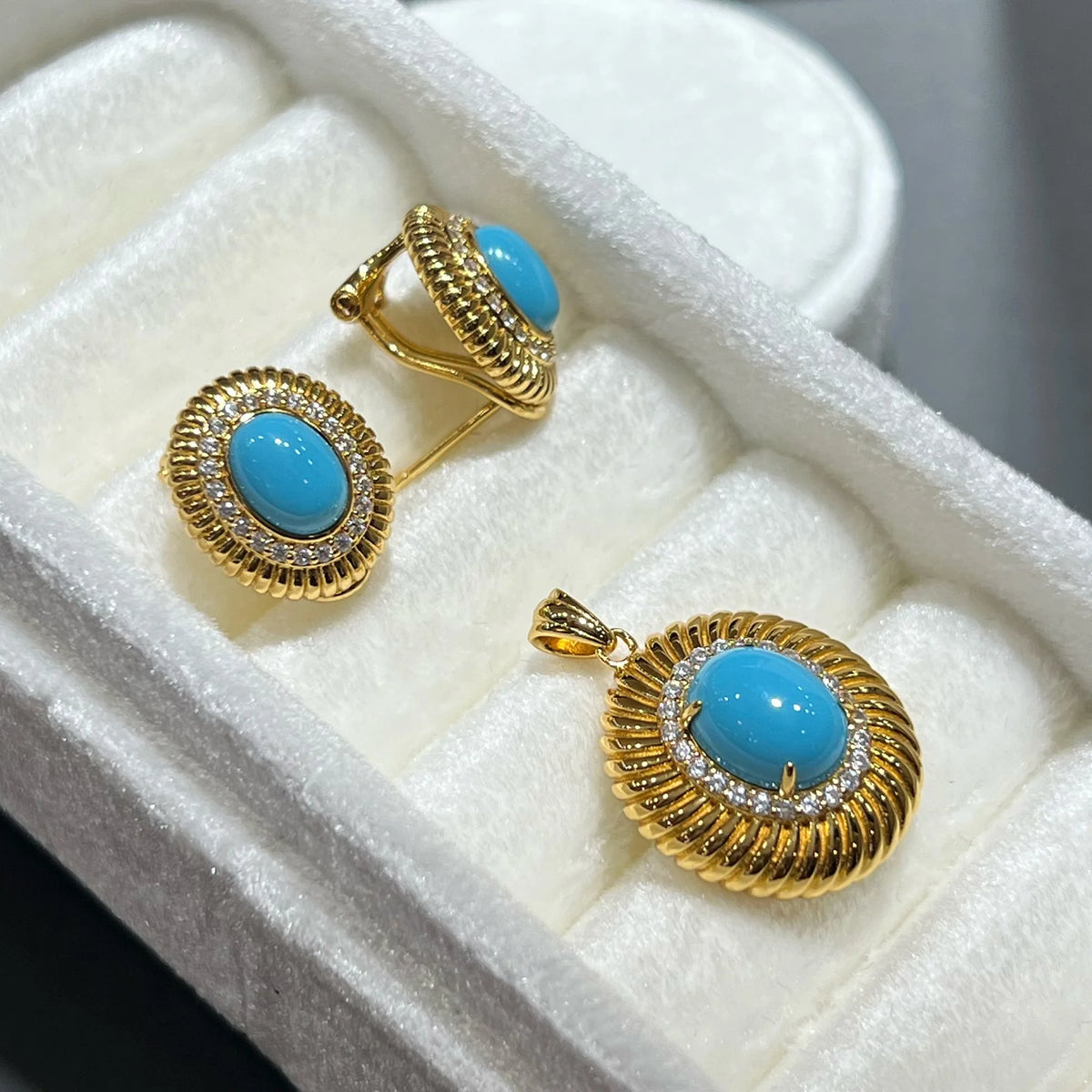 Side view of pierced turquoise earrings and matching pendant with 5A cubic zirconia halos