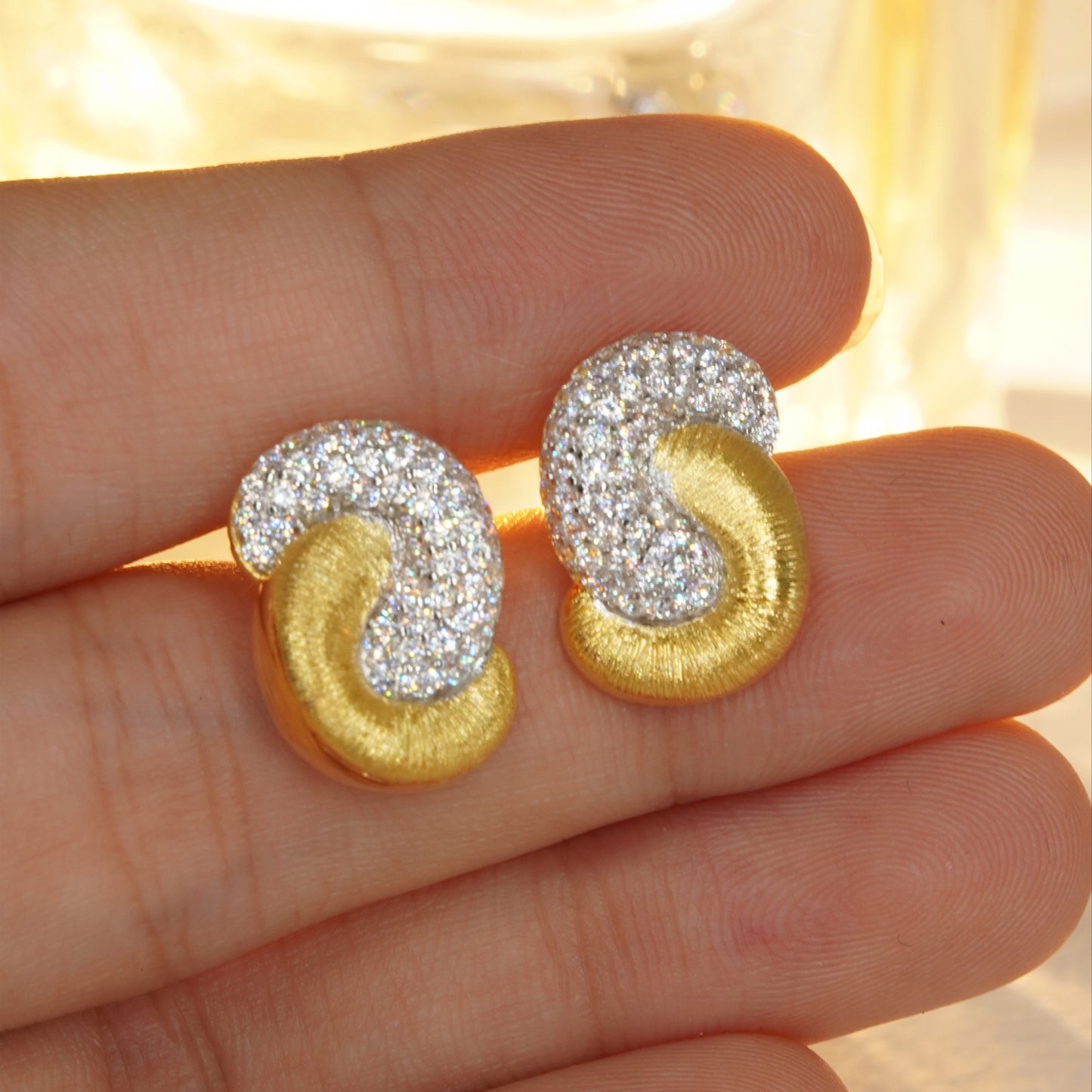 close up of brushed gold CZ hoop earrings showing luxury jewelry details