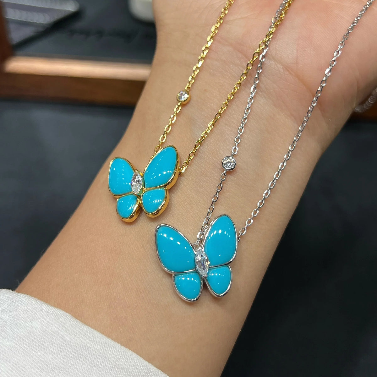 Gold and silver butterfly necklaces with created turquoise and cubic zirconia