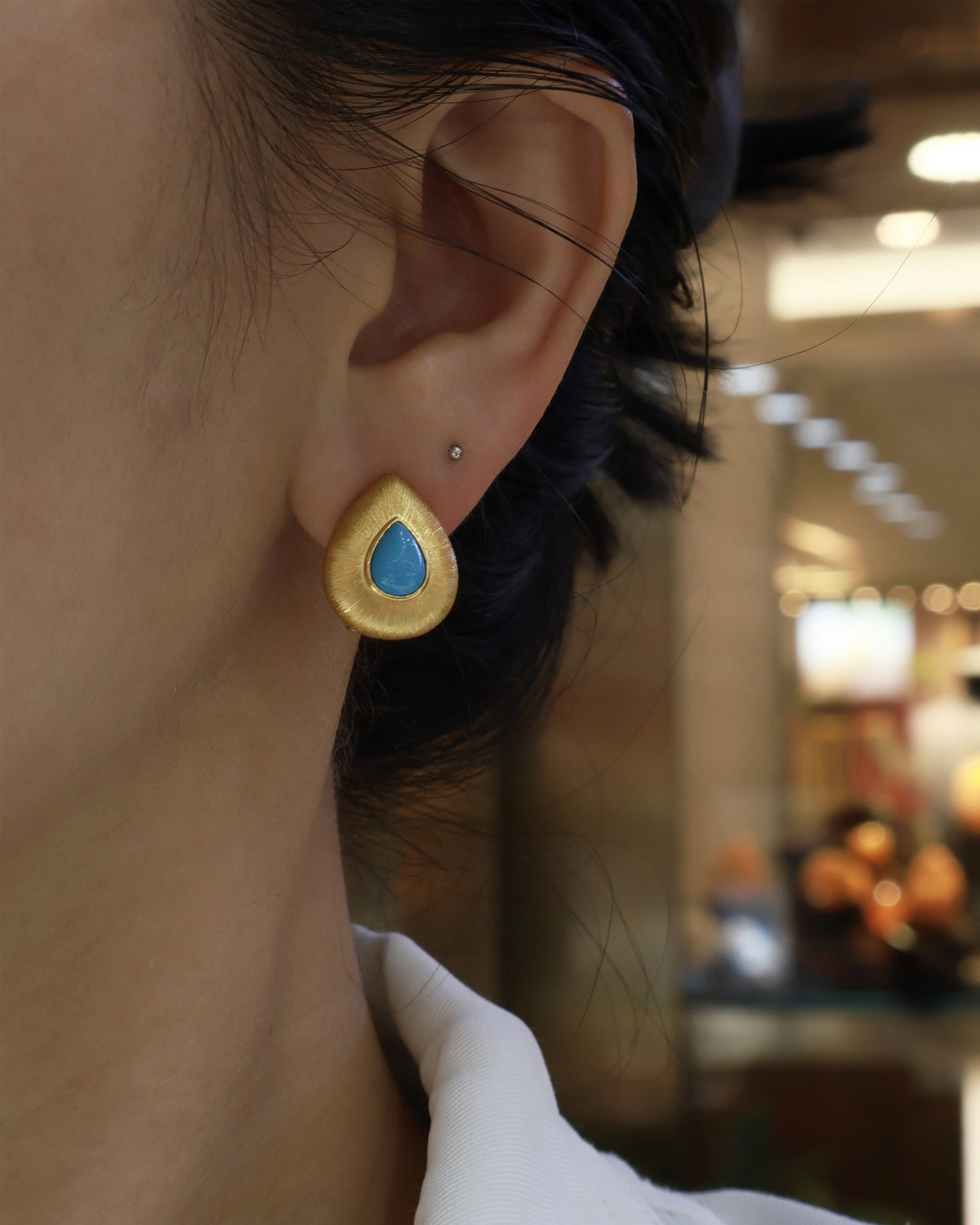 Turquoise Brushed Gold Teardrop Earrings on Model - Noble Aurora