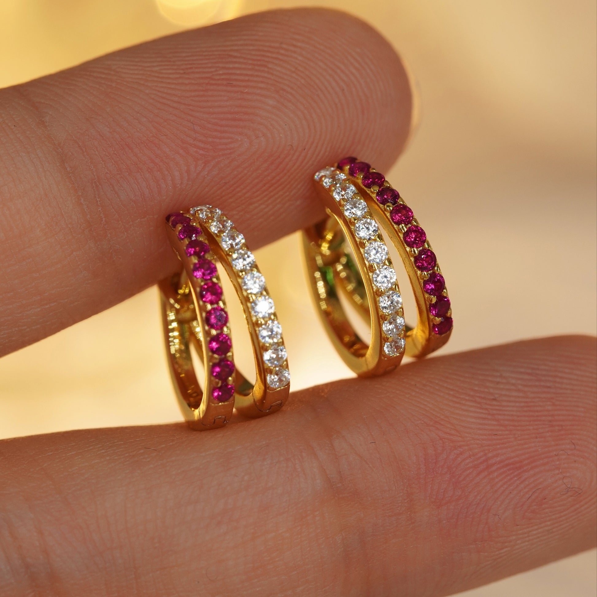 close up of ruby cubic zirconia hoop earrings showing luxury jewelry craftsmanship