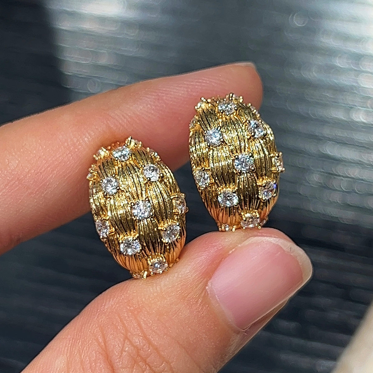 Brushed Gold CZ Oval Stud Earrings Handheld View - Noble Aurora