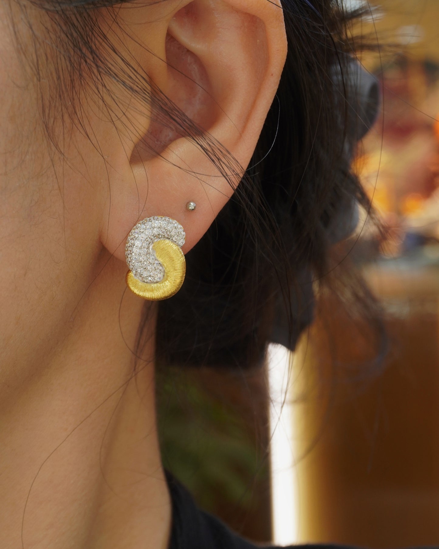 woman wearing elegant brushed gold cubic zirconia hoop earrings