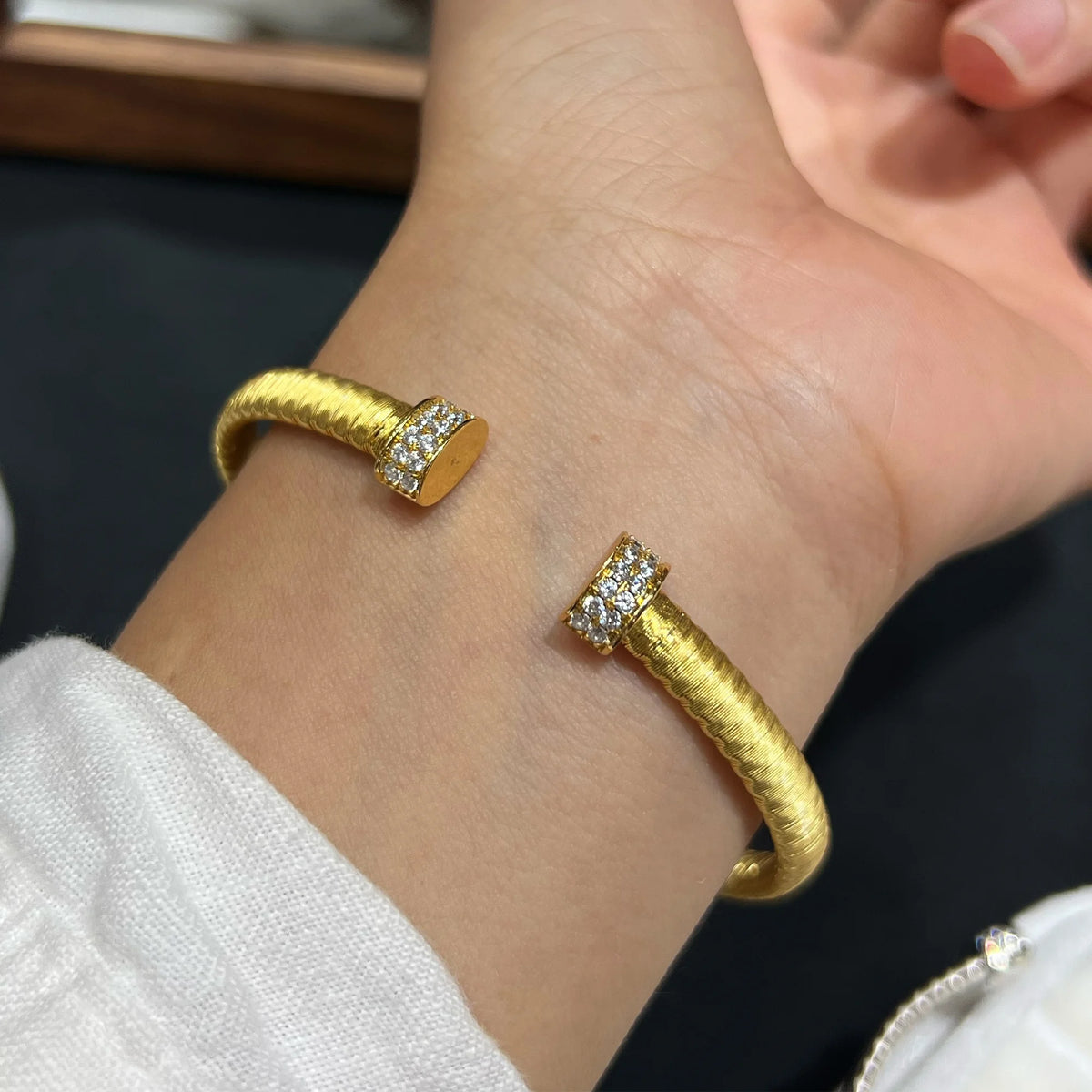 Gold cuff bracelet with pavé 5A cubic zirconia end caps