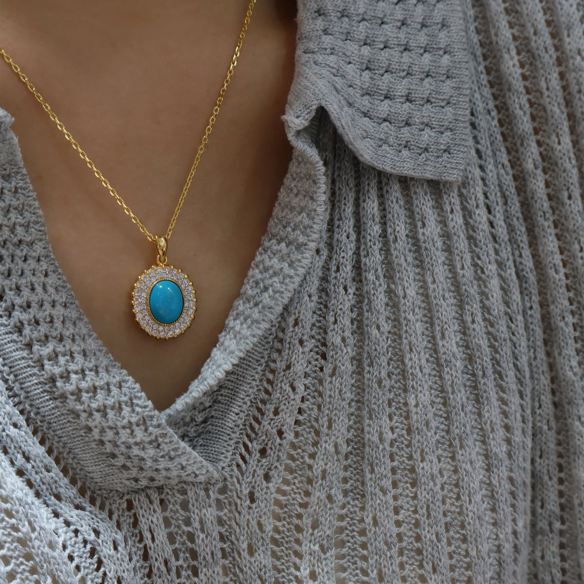 Model styling the created turquoise halo pendant; chain shown is not included
