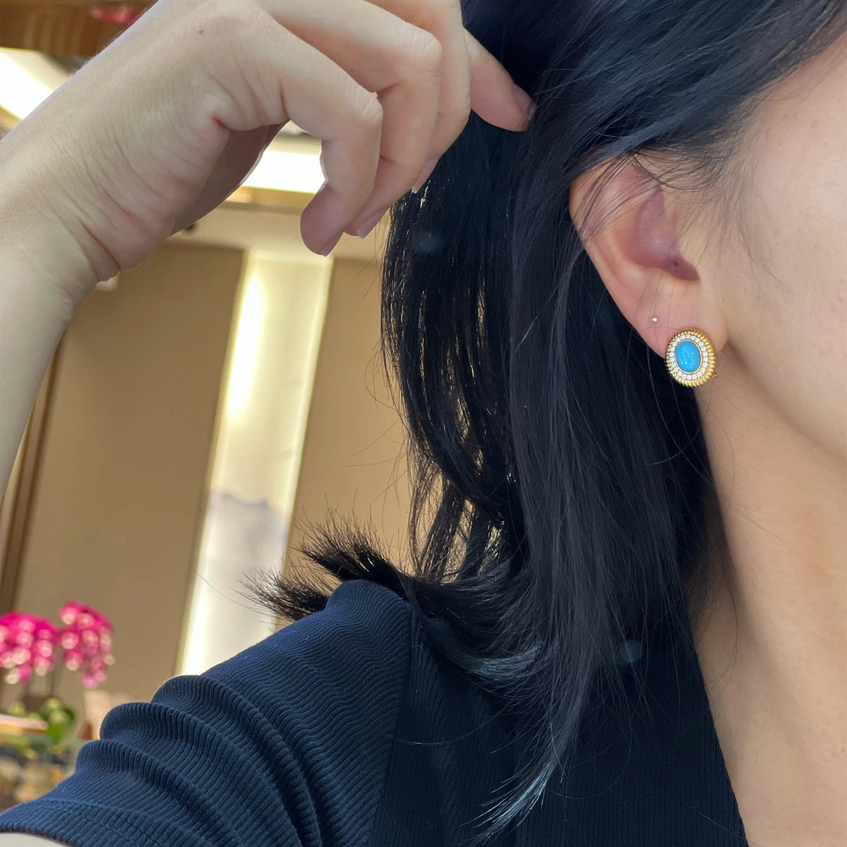 Model wearing an Azure Radiance pierced turquoise earring