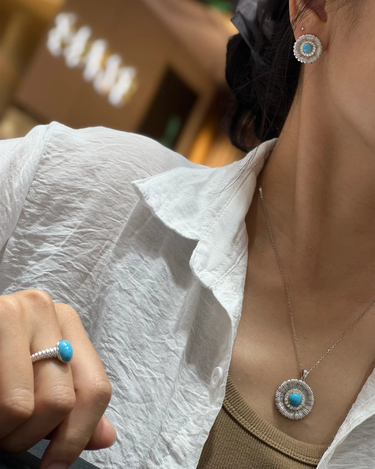 Model styling the pierced earrings and pendant; chain and ring not included