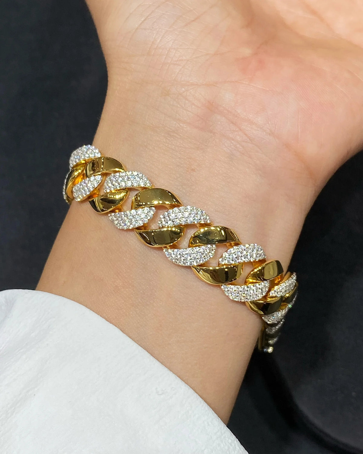 Model wearing sculpted two-tone pave Cuban link bracelet