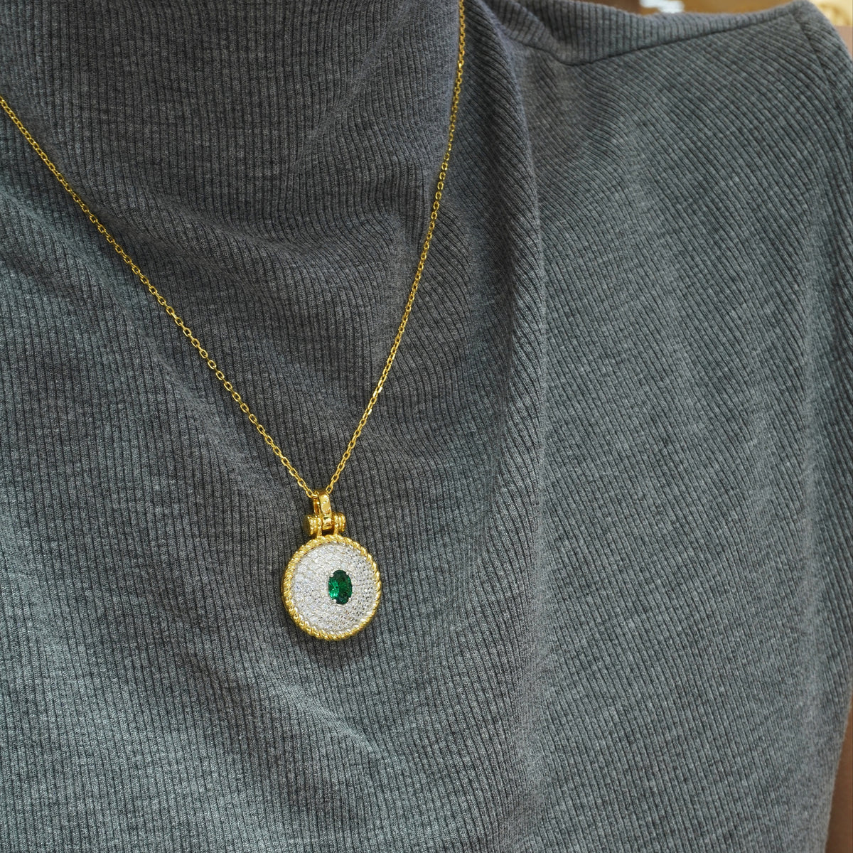 Green oval CZ pendant styled on a chain not included