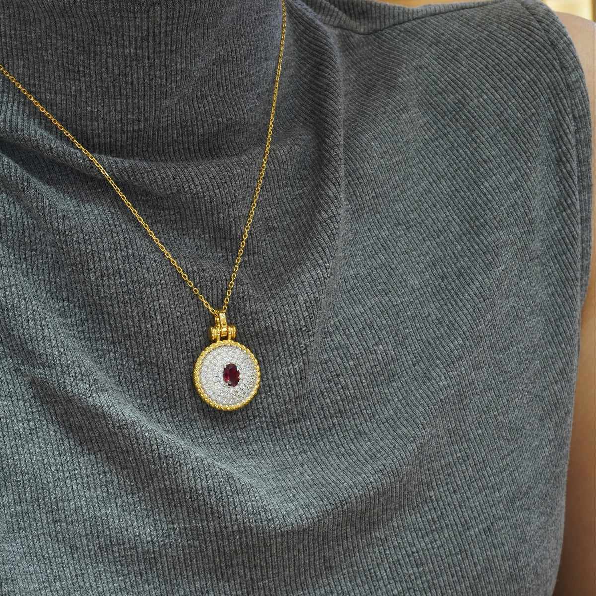 Red oval CZ pendant styled on a chain not included