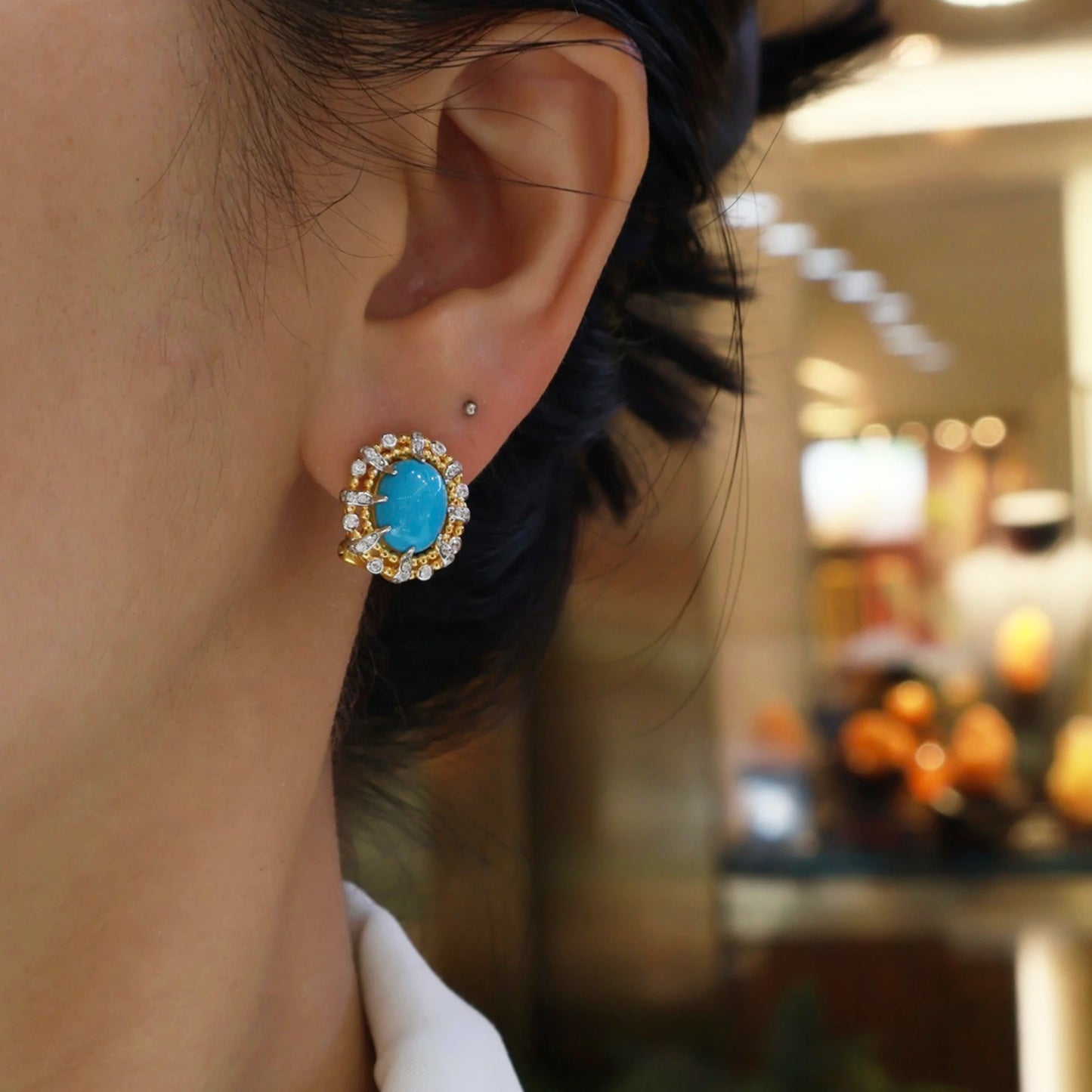 woman wearing elegant turquoise halo stud earrings gold vintage jewelry