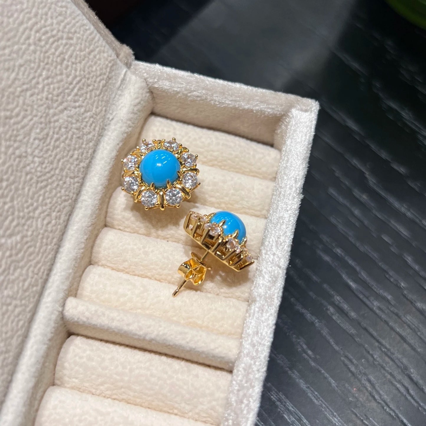 created turquoise earrings side view showing sterling silver post and gold plated setting