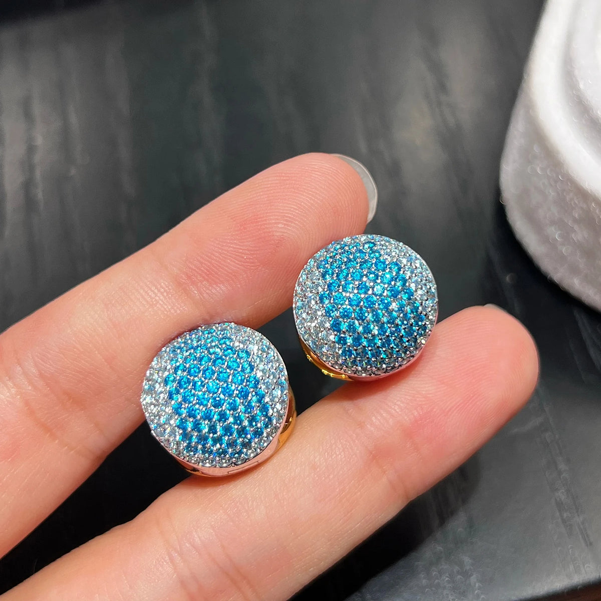 Close up of blue CZ hoop earrings showing detailed pavé stone setting