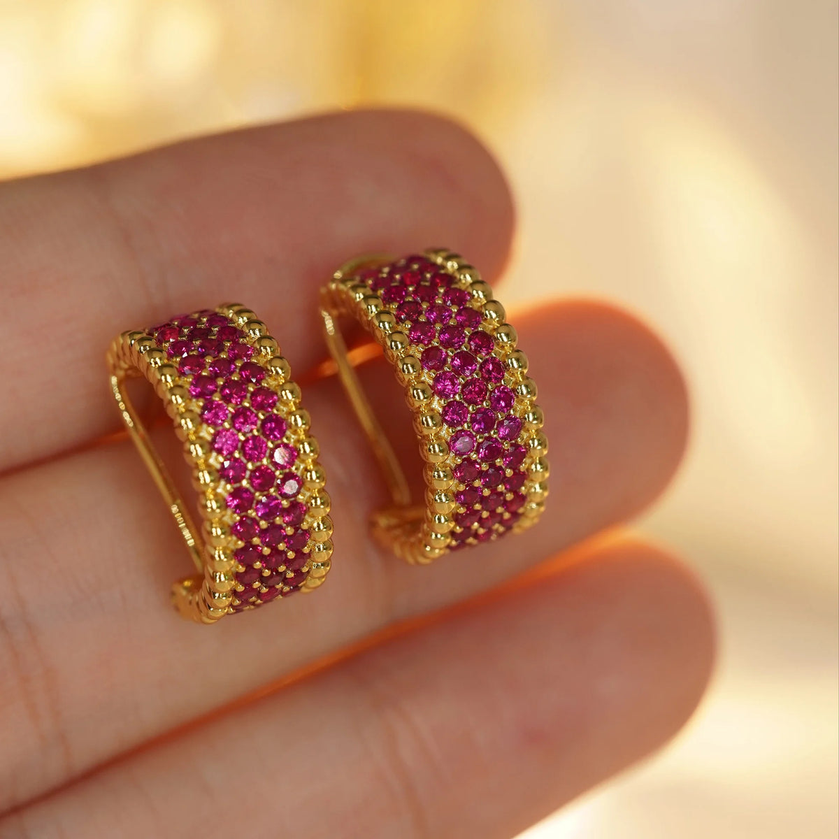 Gold red CZ beaded-edge hoop earrings, close-up detail