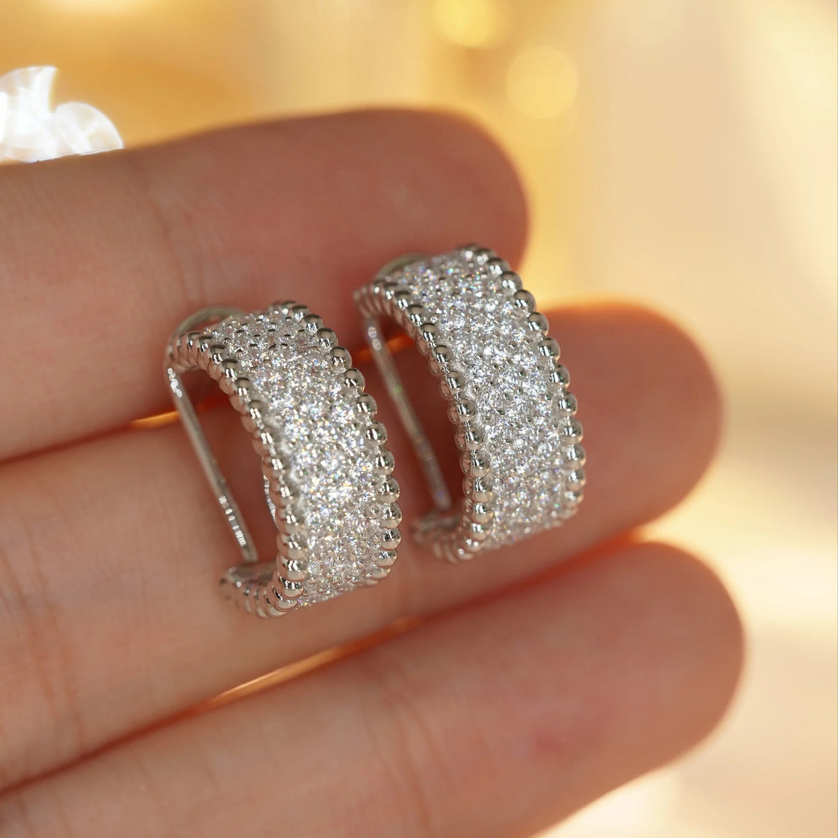 Silver clear CZ beaded-edge hoop earrings, close-up detail