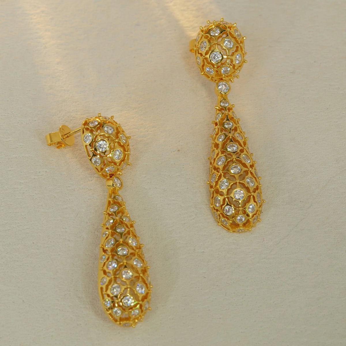 Gold openwork floral pavé CZ drop earrings, front view