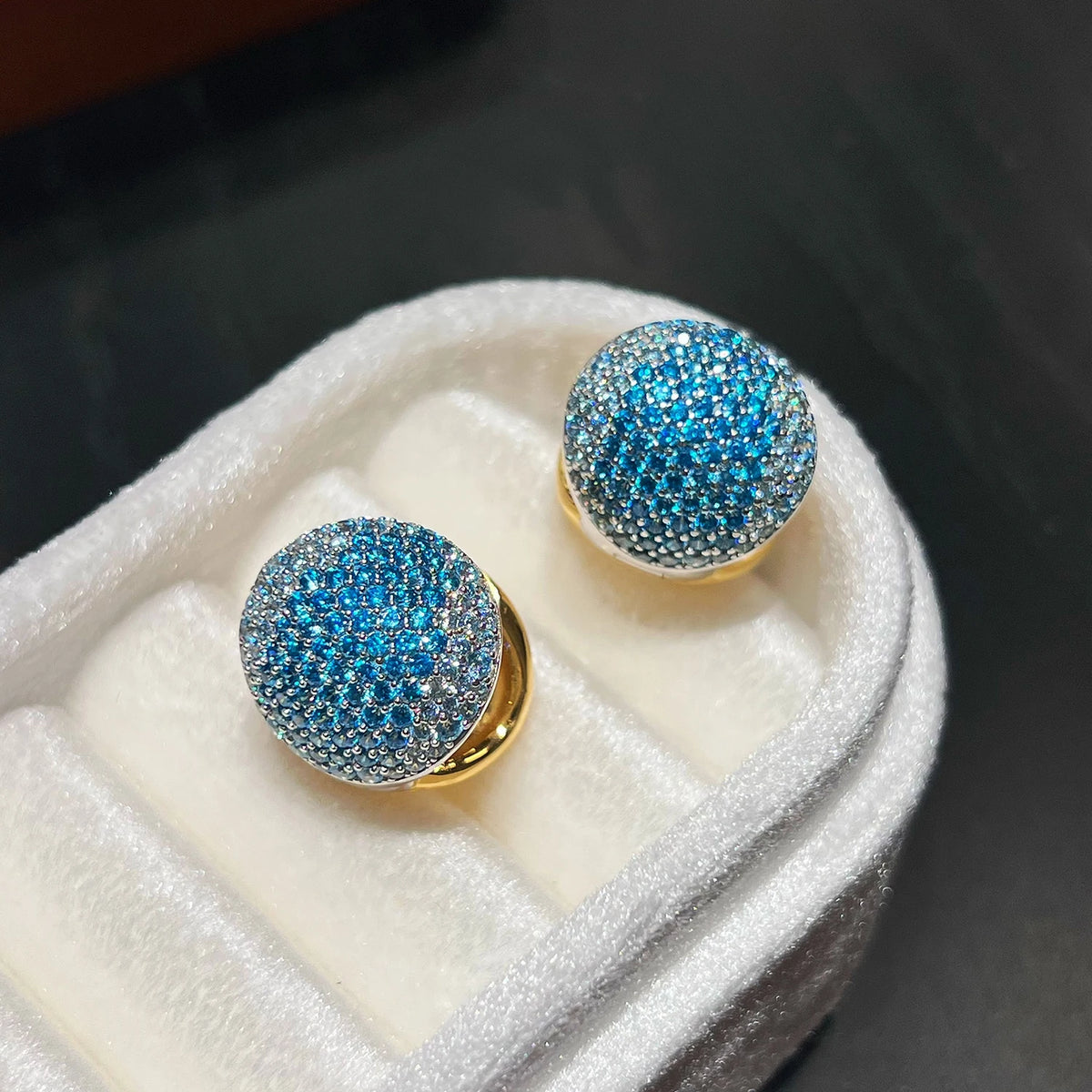 Blue pavé cubic zirconia huggie earrings with sparkling gemstone detail