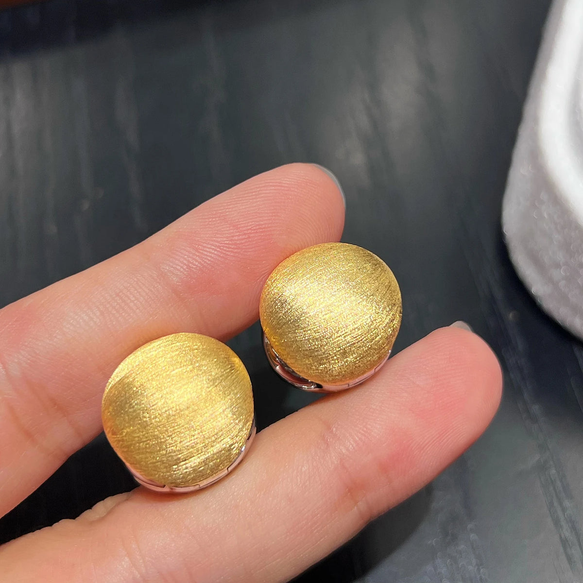 Brushed gold side of reversible huggie earrings with textured 18K gold plating