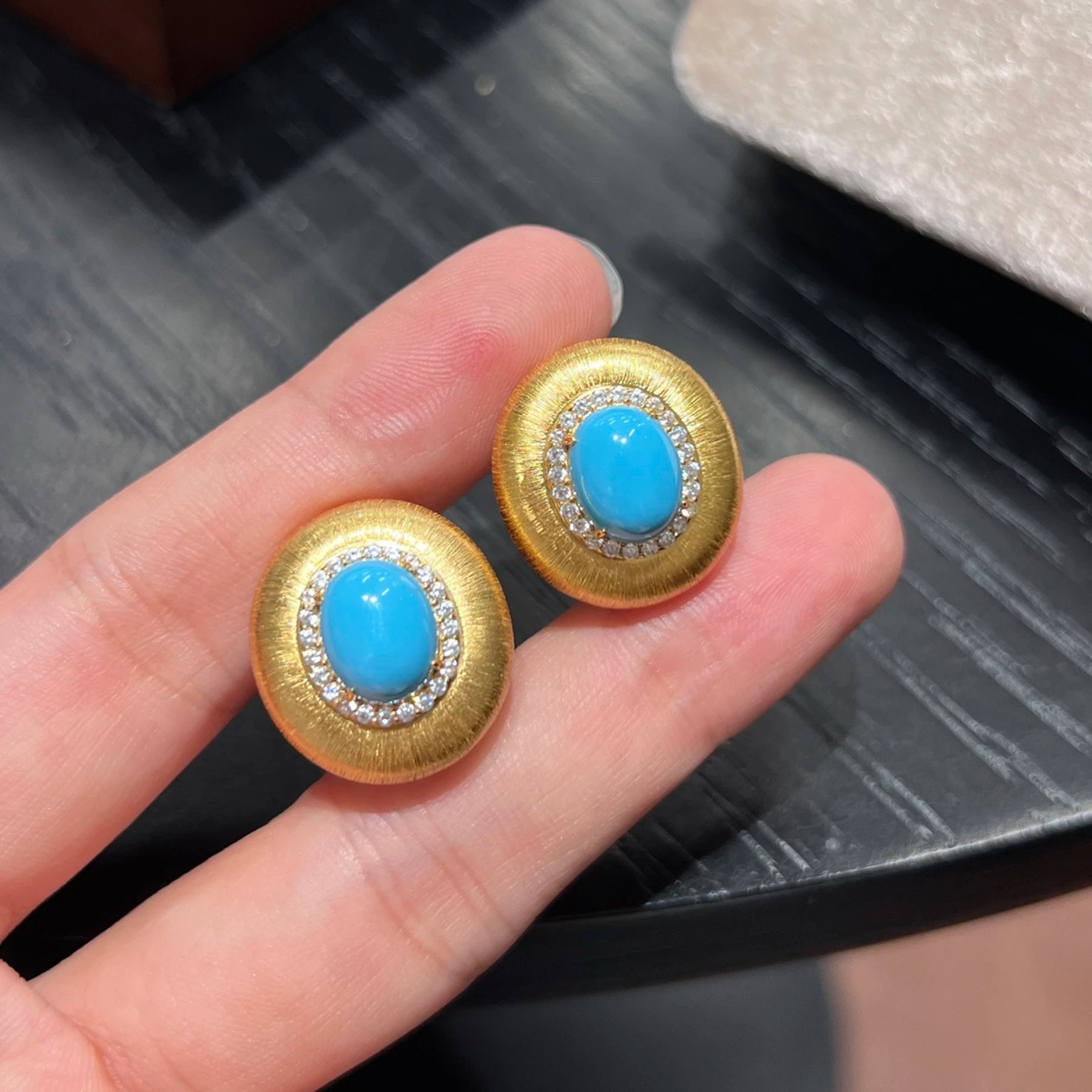 close up of created turquoise stud earrings with cubic zirconia halo