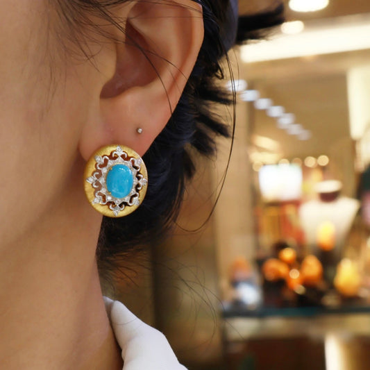 woman wearing vintage turquoise halo stud earrings with gold finish